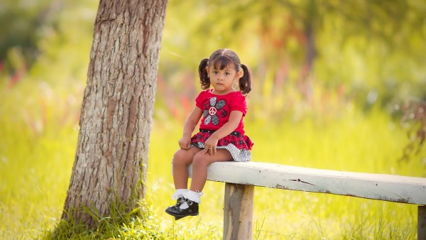 Маленькая девочка сидит на лавочке обои