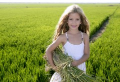 Маленькая девочка с сеном в поле